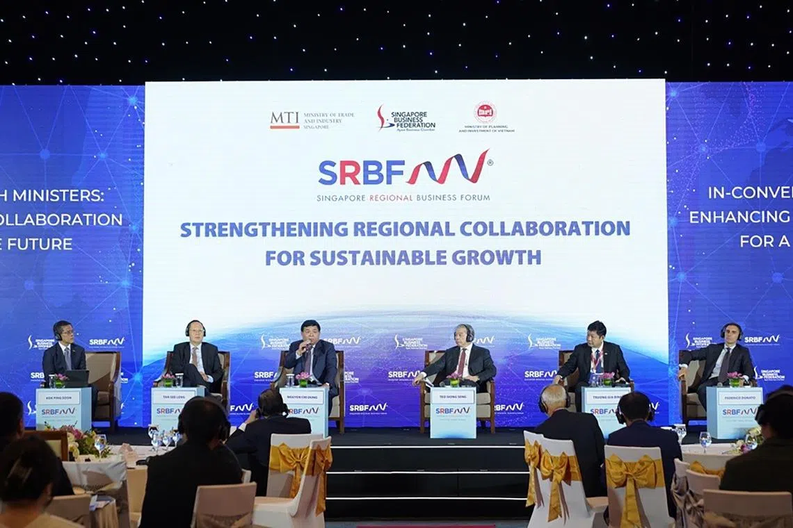 hnvietnam07 - Minister for Manpower Tan See Leng (second from left) was one of five panellists in a discussion on enhancing regional collaboration for a sustainable future moderated by Singapore Business Federation chief executive Kok Ping Soon (left). The other panellists were (from left to right) Mr Nguyen Chi Dung, Vietnam's Minister of Planning and Investment; Mr Teo Siong Seng, executive chairman of Pacific International Lines; Dr Truong Gia Binh, chairman of FPT Corporation and Mr Federico Donato, immediate past president of the European Chamber of Commerce Singapore.

Credit: Singapore Business Federation