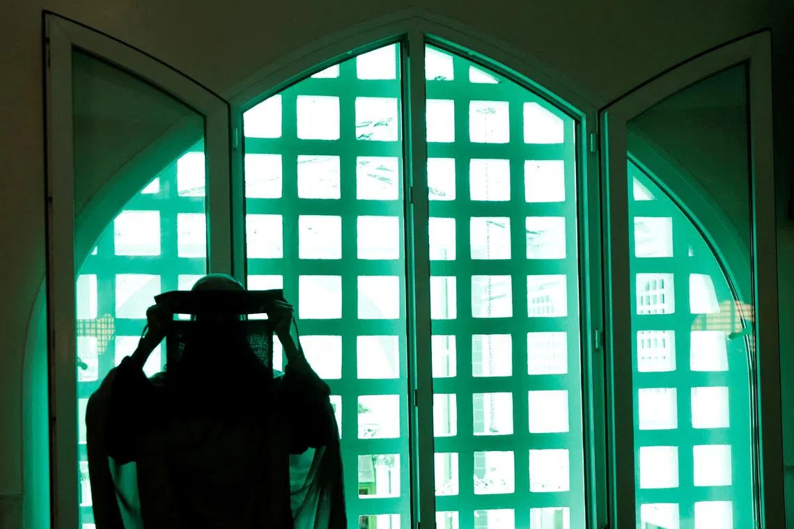 A Muslim woman prepares to attend the Friday prayers during the holy fasting month of Ramadan at the Jamia Mosque in downtown Nairobi, Kenya March 14, 2025. REUTERS/Monicah Mwangi