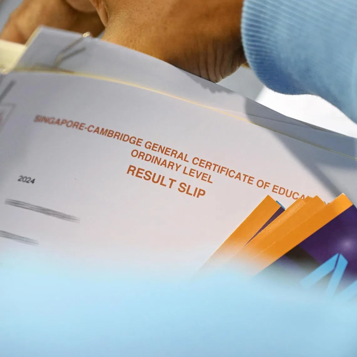 ST20250110_202586100849 Kua Chee Siong/ pixolevel10/ Generic pix of a teacher preparing to distribute the certificates and results of the 2024 GCE O-Level examinations to the students at St Andrew's Secondary School, on Jan 10, 2025.