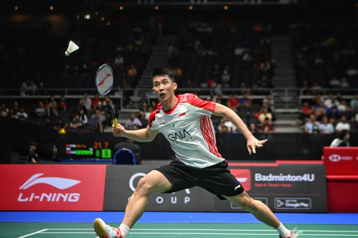 Singapore (in white), Loh Kean Yew, against France, (in blue) Popov Christo, during round 2 of 16 at the Singapore Badminton Open at Singapore Indoor Stadium on Jun 8, 2023.