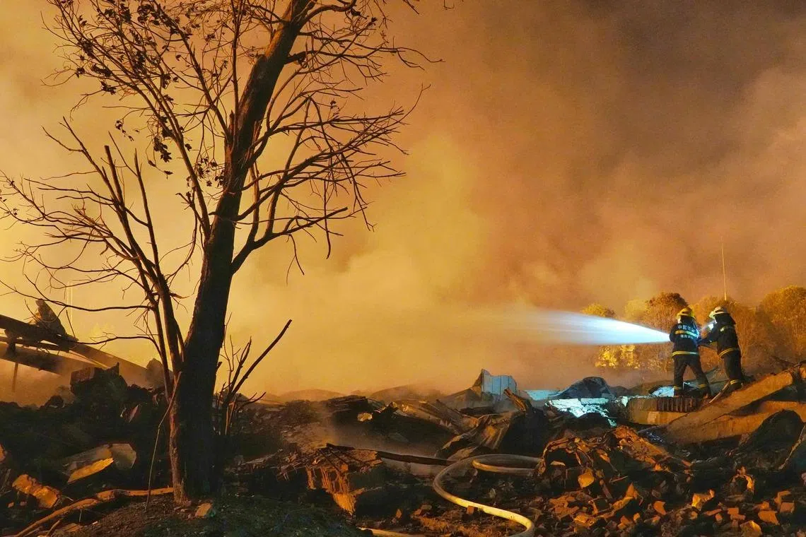 Firefighters spray water at the scene of a fireworks factory explosion in Liuyang, in China’s central Hunan province early on May 5, 2026. A giant explosion at a fireworks factory in central China killed at least 21 people and injured 61, state media said on May 5. The explosion occurred at around 4:43 pm on May 4 at the Liuyang Huasheng Fireworks Manufacturing and Display Company in Liuyang, Hunan province, state broadcaster CCTV said. (Photo by CNS / AFP) / - China OUT