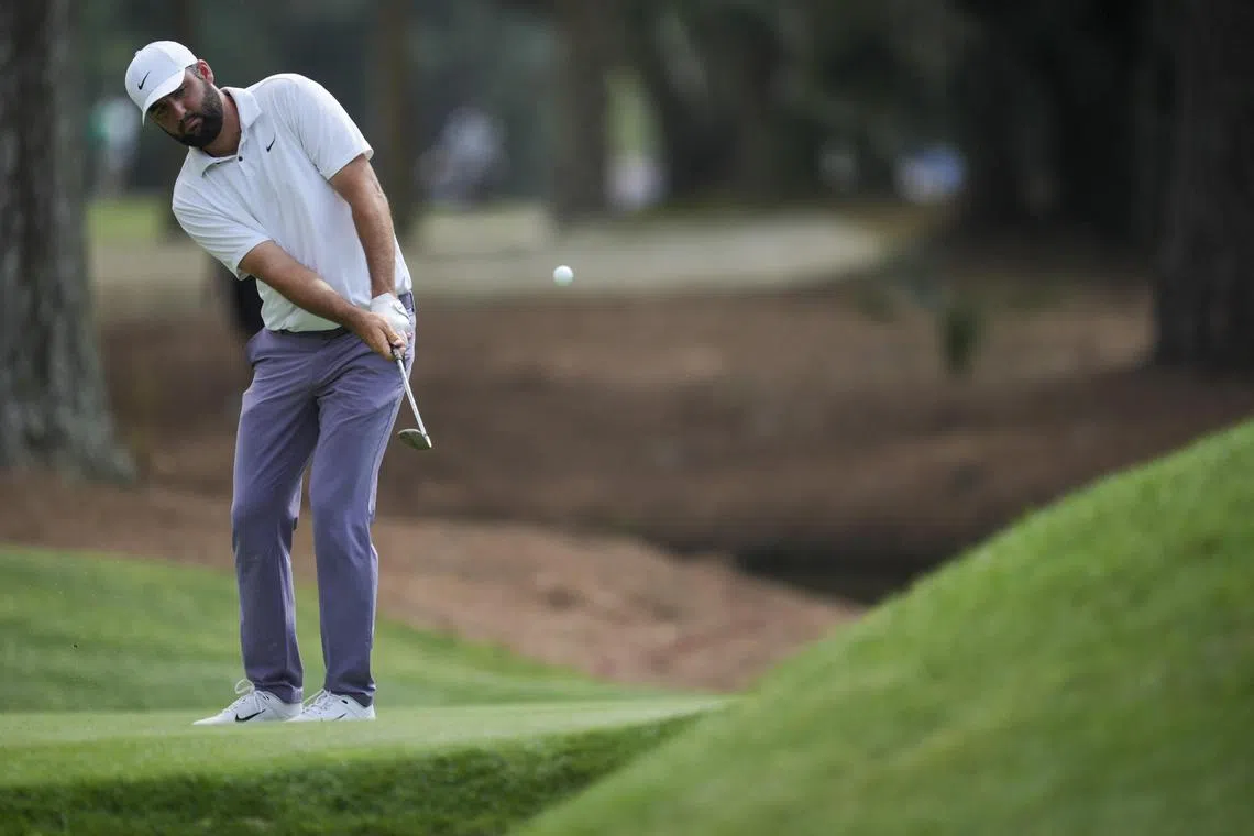 Leader Scottie Scheffler chips onto the 15th green during the third round of the RBC Heritage golf tournament.