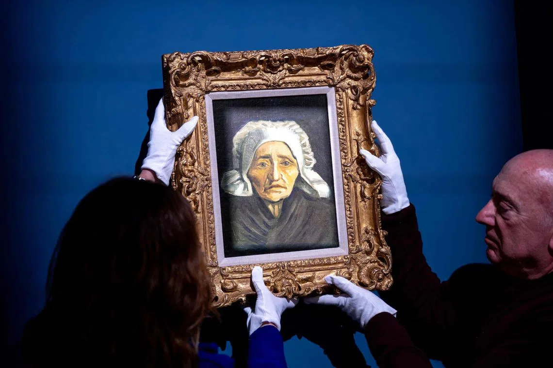 Personnel members hang for display a rare Vincent van Gogh painting, "Tete de paysanne a la coiffe blanche" (Head of an old farmer's wife with a white hat), painted circa 1884, that will be auctionned at the TEFAF Maastricht art fair, in Maastricht, on March 6, 2024. The TEFAF Maastricht art fair runs from March 9 to 14, 2024. (Photo by Nick Gammon / AFP) / RESTRICTED TO EDITORIAL USE - MANDATORY MENTION OF THE ARTIST UPON PUBLICATION - TO ILLUSTRATE THE EVENT AS SPECIFIED IN THE CAPTION