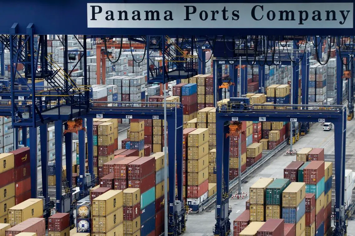 A Panama Ports Company sign is seen over containers at the Balboa port in Panama City October 10, 2014. REUTERS/Carlos Jasso/File Photo