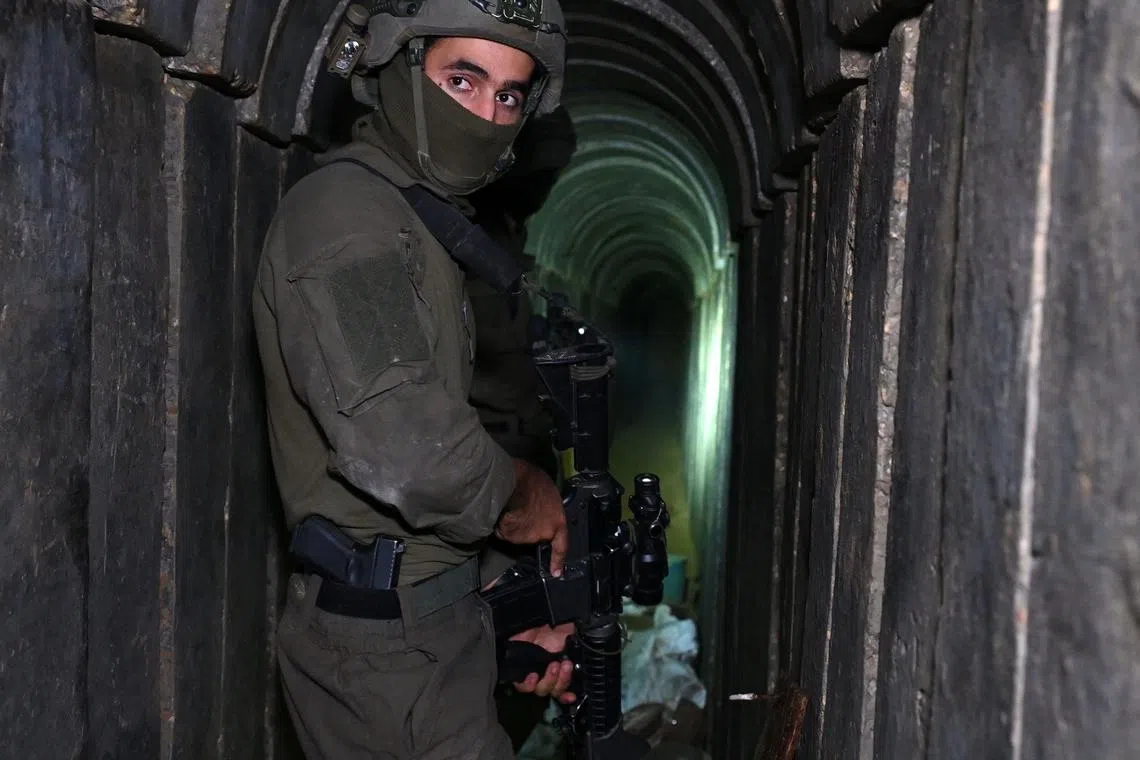 A soldier stands in what the Israeli army says is a tunnel dug by Hamas militants inside the Al-Shifa hospital complex in Gaza City.
