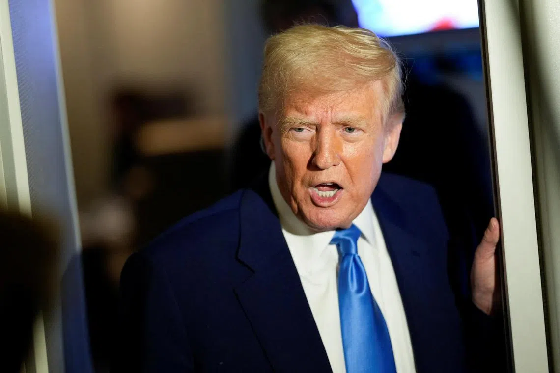 U.S. President Donald Trump talks to members of the press aboard Air Force One during a flight to Joint Base Andrews, Maryland, U.S., April 6, 2025. REUTERS/Kent Nishimura