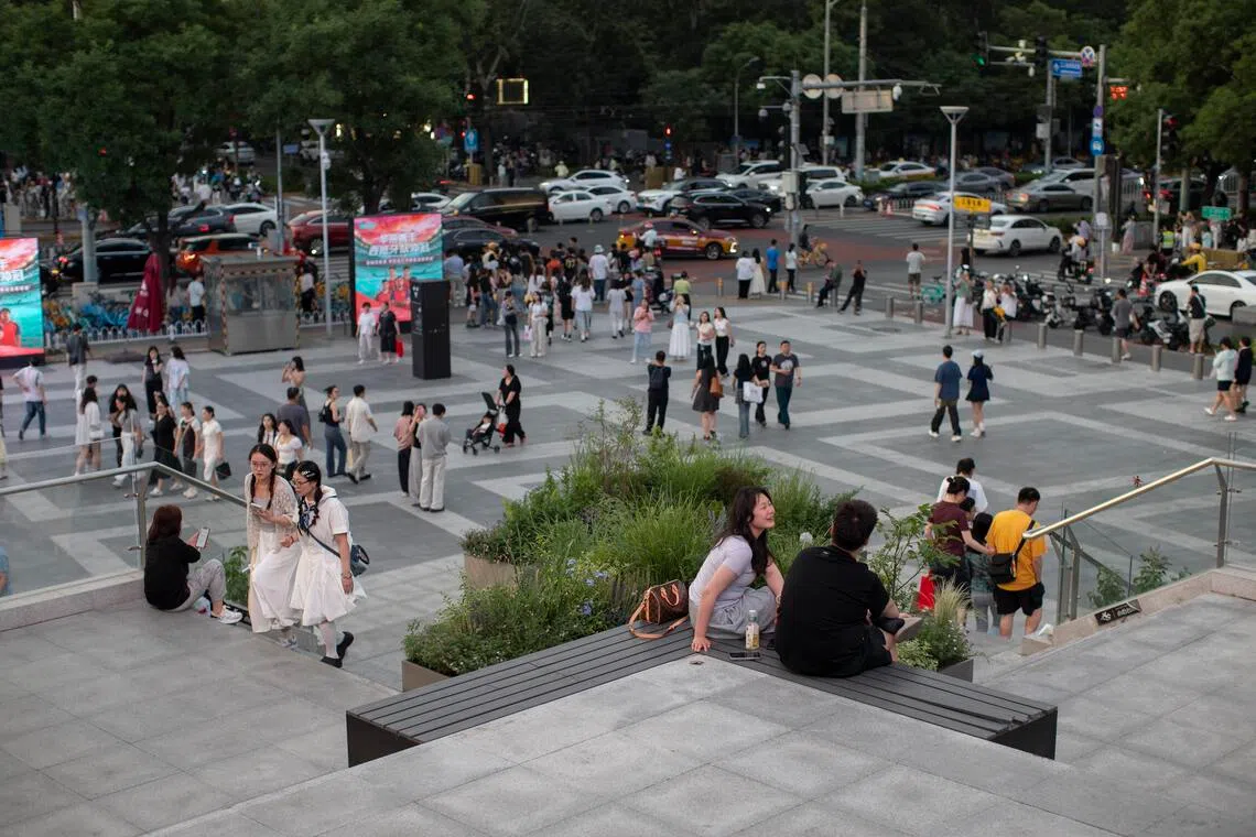 People stand outside a mall in Beijing, China, on May 31.