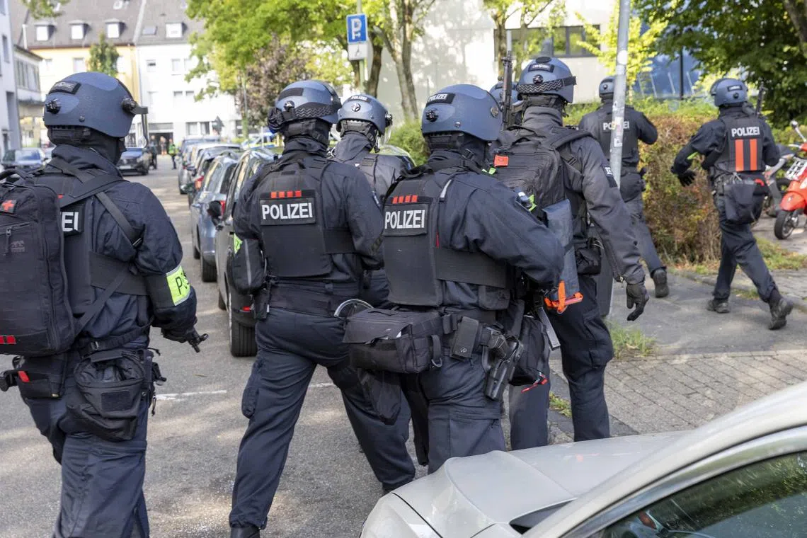 Policemen are seen on Sept 5, outside a vocational college in Essen, western Germany, where a teacher has been injured in a stabbing.