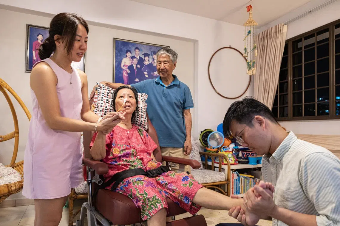 Mr Alvin Yap (from right) stays with his father Mr Ron Yap, and mother Mdm Cecilia Wong. His sister, Ms Kimberly Yap, also visits everyday to care for their parents. The family receives $1,800 of financial aid from the government each month, which helps in the management of the long-term care costs.
