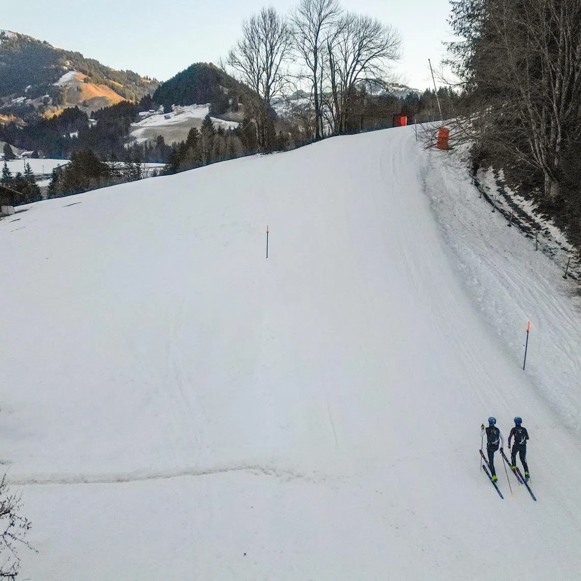 A drone view shows twin brothers Robin and Thomas Bussard climbing up during a ski mountaineering training session in Rougemont, Switzerland, December 18, 2025. REUTERS/Denis Balibouse