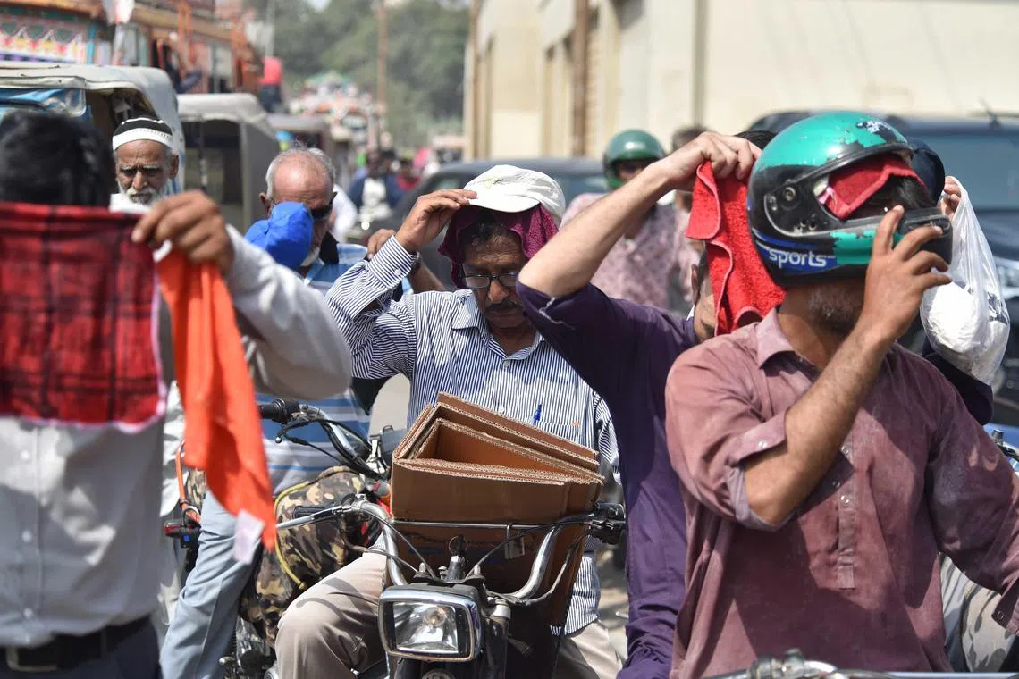 epa11438987 People cover their heads in wet towels during a heatwave in Karachi, Pakistan, 26 June 2024. The heatwave in Karachi has led to the hospitalization of 1,592 individuals at Jinnah Hospital within the past 24 hours, resulting in 49 fatalities, including 29 brought in dead, according to doctors. The city, currently experiencing extreme heat due to the suspension of sea breeze, witnessed its hottest day of 2024 on 24 June, with temperatures soaring to a record 42 degree Celsius. Residents are advised to avoid sun exposure between 10am and 4pm.  EPA-EFE/SHAHZAIB AKBER