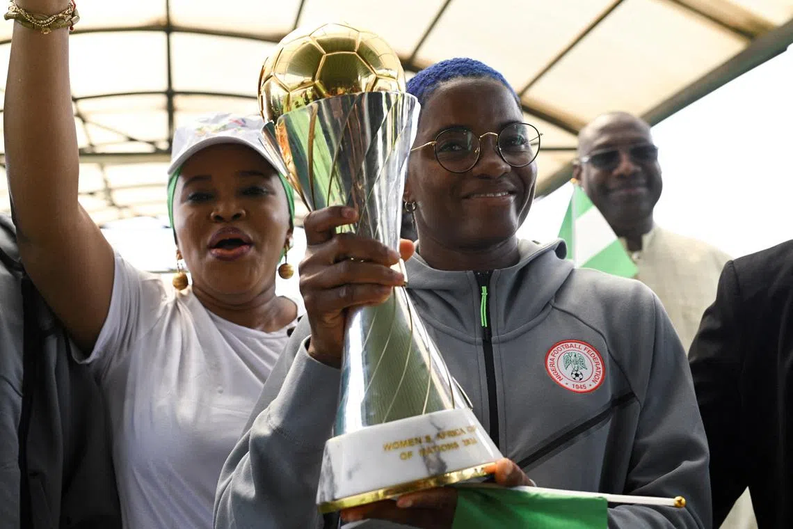 FILE PHOTO: Nigeria’s Super Falcons captain Rasheedat Ajibade holds the Women’s Africa Cup of Nations (WAFCON) trophy as supporters cheers at Nnamdi Azikiwe International Airport in Abuja, following the team’s victory in Morocco, July 28, 2025. REUTERS/Marvellous Durowaiye/File Photo