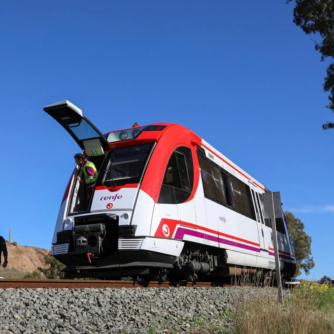 Police officers working at the site where a commuter train collided with a crane in Spain's Murcia region on Jan 22.