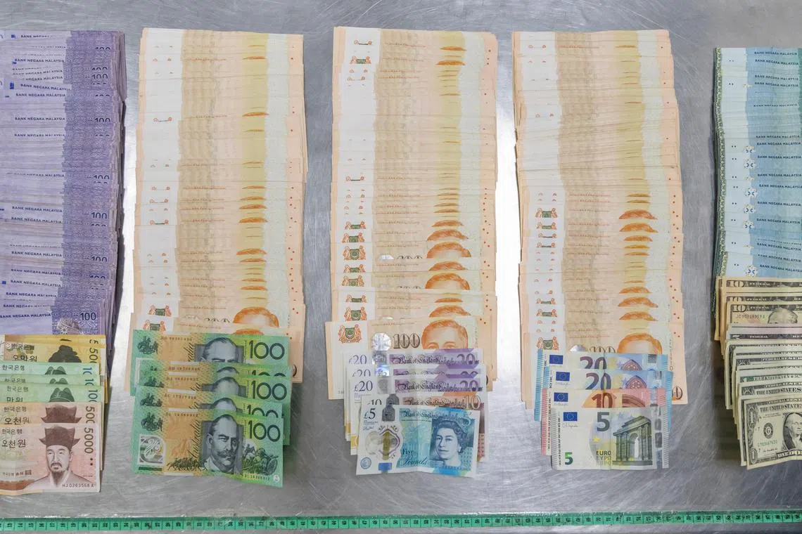 Investigations into the two travellers who carried undeclared money of various currencies exceeding a total of $140,000 into Singapore are ongoing. 