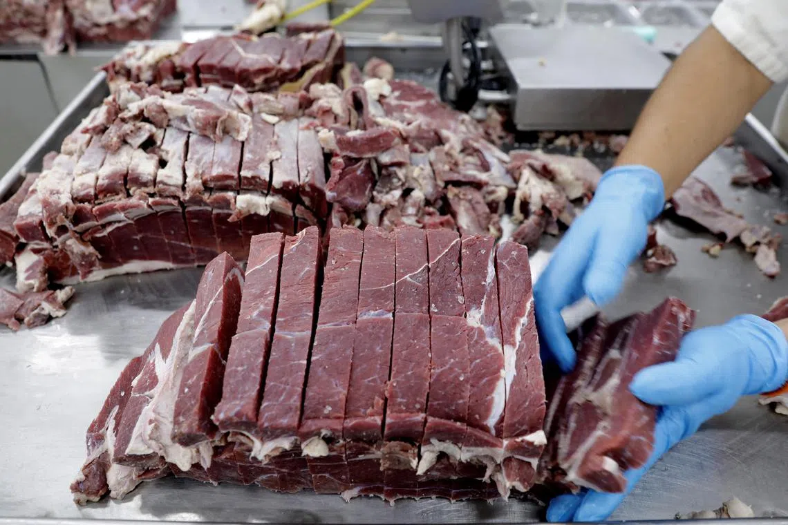FILE PHOTO: An employee works at the assembly line of jerked beef at a plant of JBS S.A, the world's largest beef producer, in Santana de Parnaiba, Brazil December 19, 2017. REUTERS/Paulo Whitaker/File Photo
