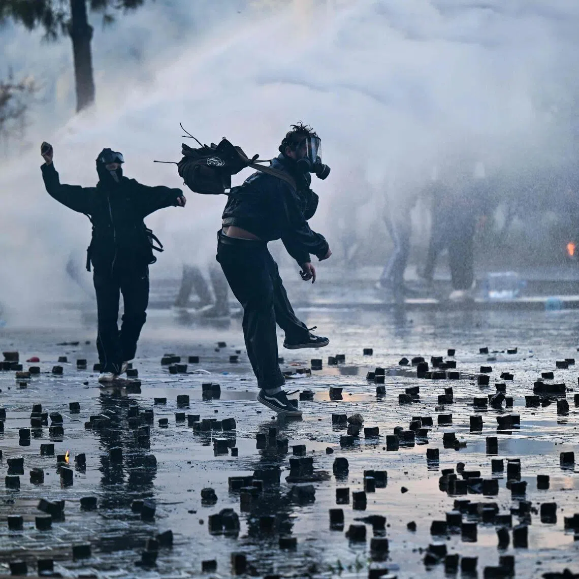 Protesters throw cobblestones during an anti-government demonstration in central Tirana on Oct 17.