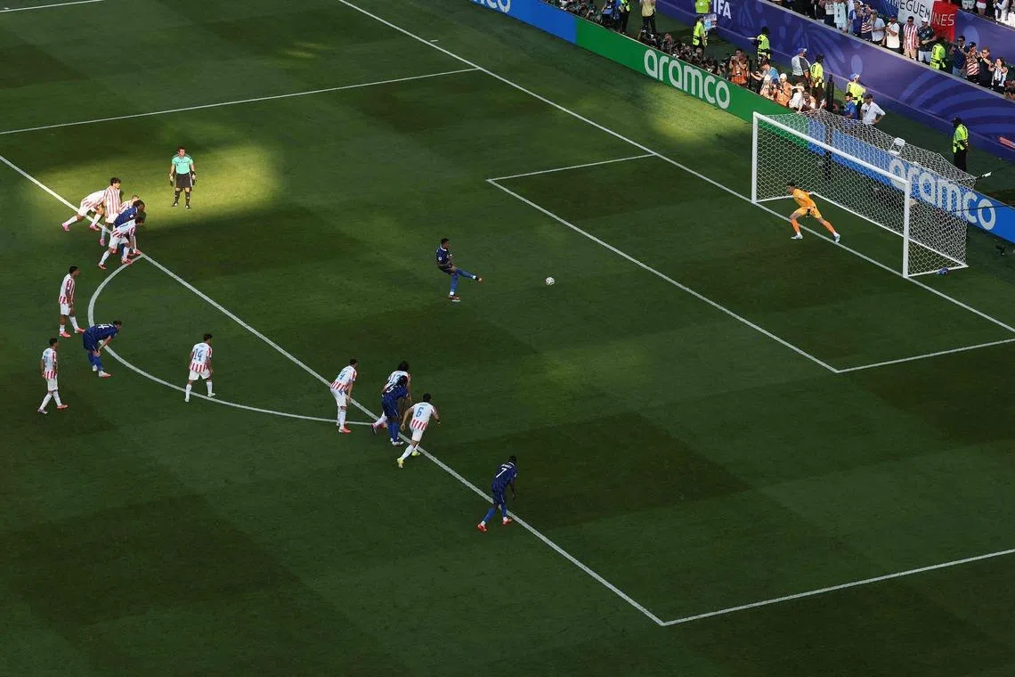Kylian Mbappe scoring France’s first goal during match against Paraguay on July 4.