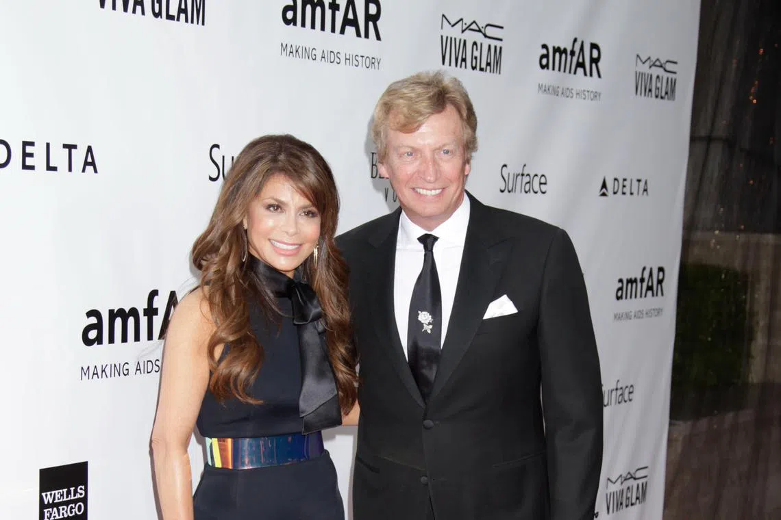 Paula Abdul and Nigel Lythgoe in a file photo from December 2013. Abdul has settled her lawsuit against Lythgoe, a long-time producer of American Idol.