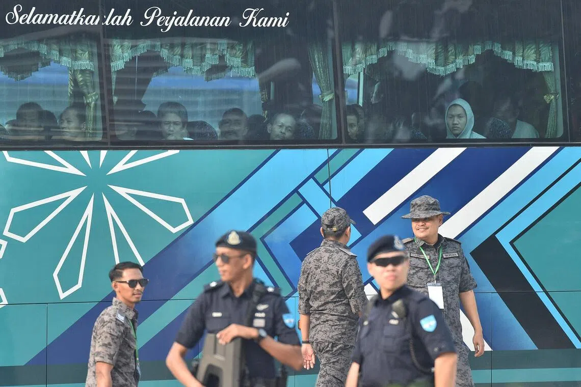 A bus carrying Myanmar nationals being repatriated from Malaysia to their homeland heading towards the naval base in Lumut on Sept 29.