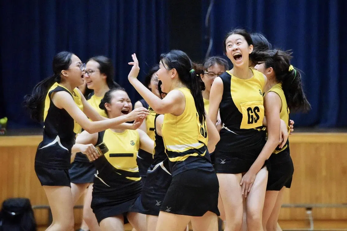 SCGS players rushing onto the court to celebrate clinching their first-ever B Division netball title. They defeated RGS 22-20 in the national final on April 22 at Jurong East Sports Hall.