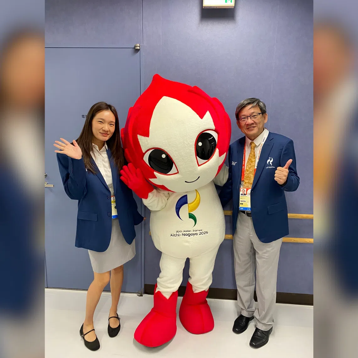 Geraldine Chew (left) and her father Steve posing with the Asian Games 2026 mascot Honohon at the Furuhashi Hironoshin Memorial Hamamatsu Swimming Centre.