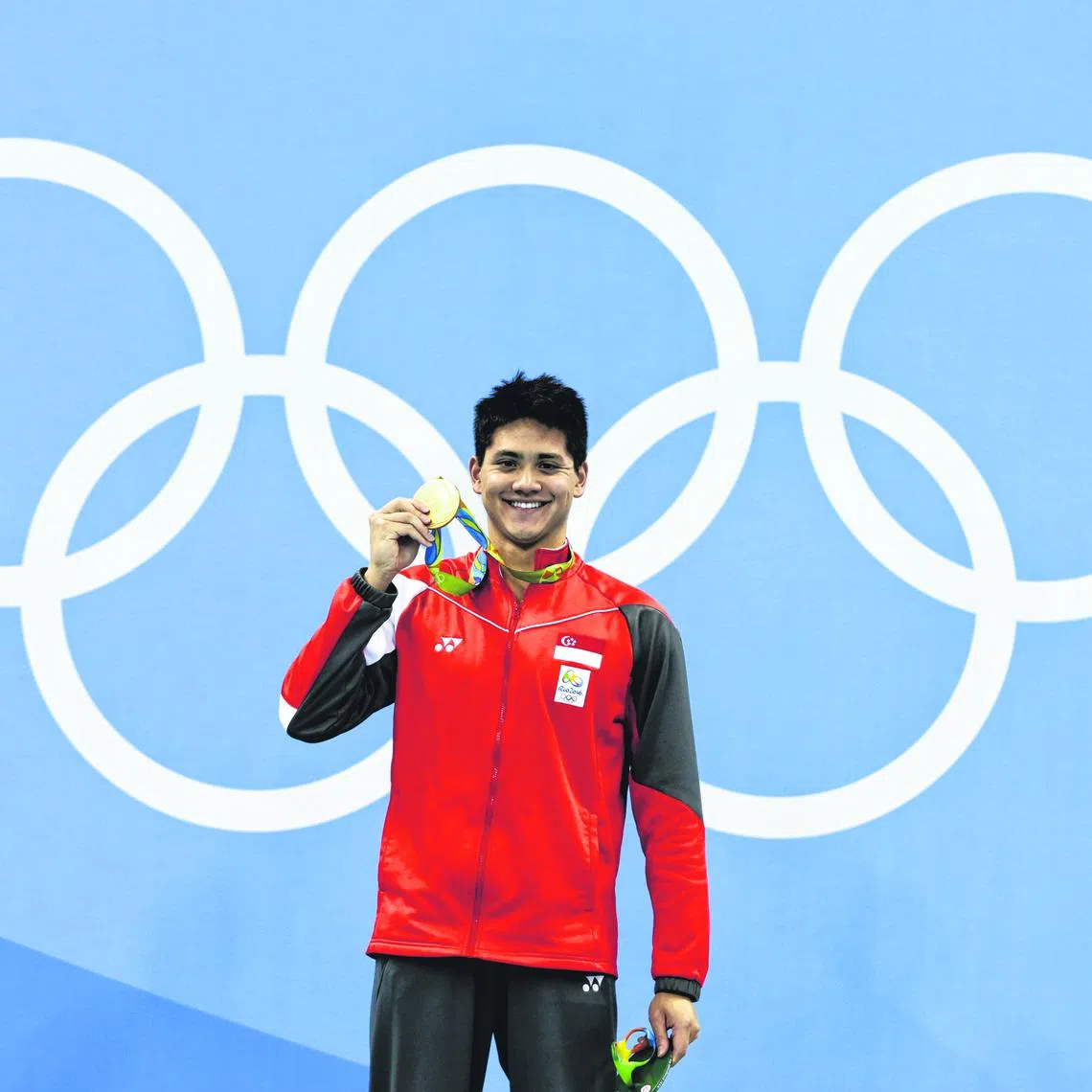 Joseph Schooling of Singapore with the gold medal on the podium after winning the Rio 2016 Olympic Games men's 100m butterfly final at the Olympic Aquatics Stadium in Rio de Janeiro, Brazil, on 12 August 2016.