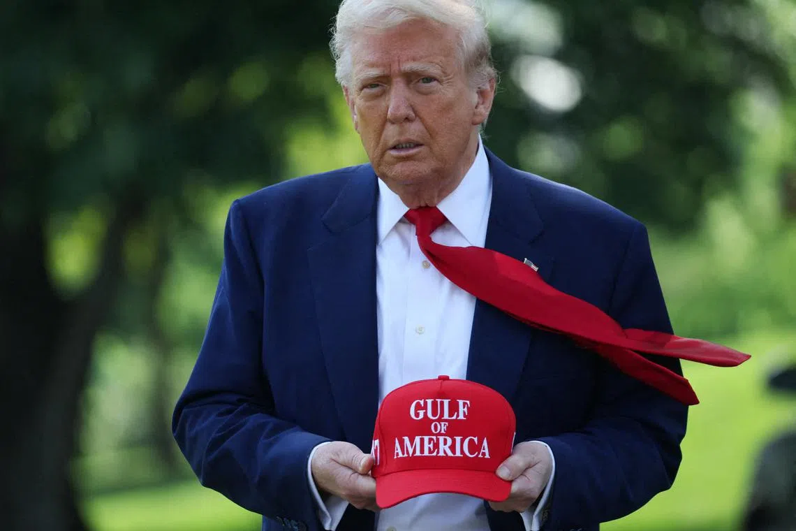 President Trump holds a cap with the words \"Gulf of America\" embroidered as he walks to board Marine One to depart for Michigan to attend a rally to celebrate his first 100 days in office, from the South Lawn of the White House. REUTERS/Leah Millis/File Photo
