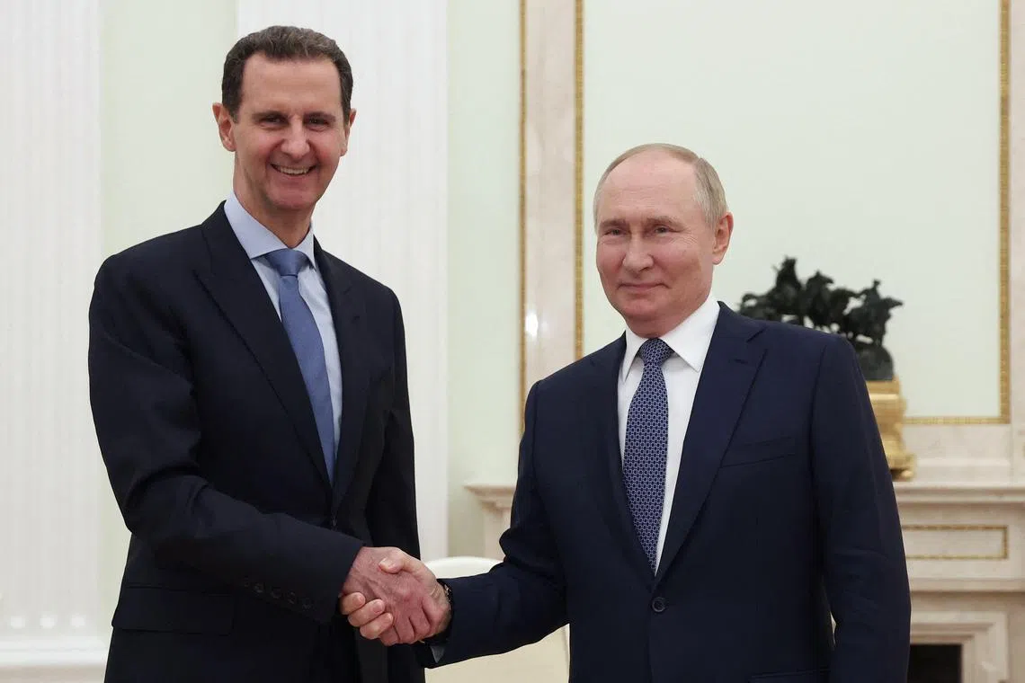 Russia's President Vladimir Putin with Syria's former president Bashar al-Assad during their meeting at the Kremlin in Moscow on July 24.