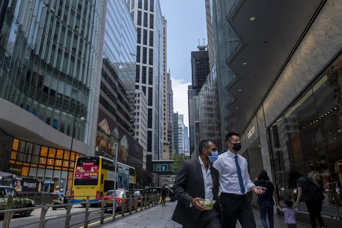 DUPLICATE IMAGE
People walk along a road during lunch hour in the Central district of Hong Kong, China, on Monday, June, 7, 2021. Goldman Sachs Group Inc. and HSBC are opening their offices fully in Hong Kong as a fourth wave of infections was contained and the U.S. investment bank said half of its staff in the financial hub are now vaccinated. Photographer: Paul Yeung/Bloomberg