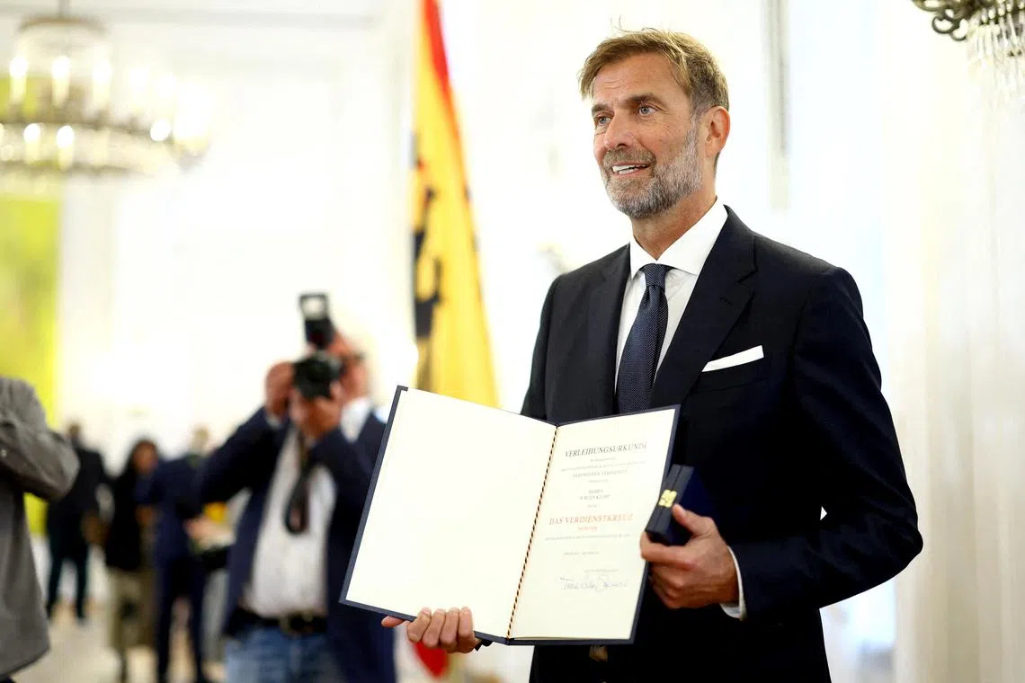 Former Liverpool manager Jurgen Klopp posing with the Order of Merit of the Federal Republic of Germany on Oct 1 at Bellevue Palace to mark the unification day in Berlin.