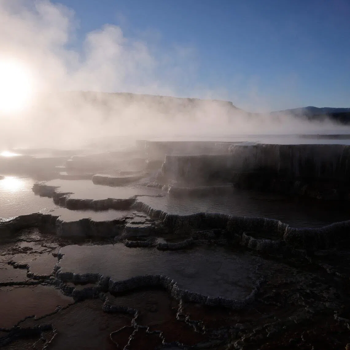 The sun rises above steam rising at Mammoth Hot Springs on May 19 in Yellowstone National Park. It has long been assumed the Sun would be engulfed by the expanding fireball of the dying Sun.
