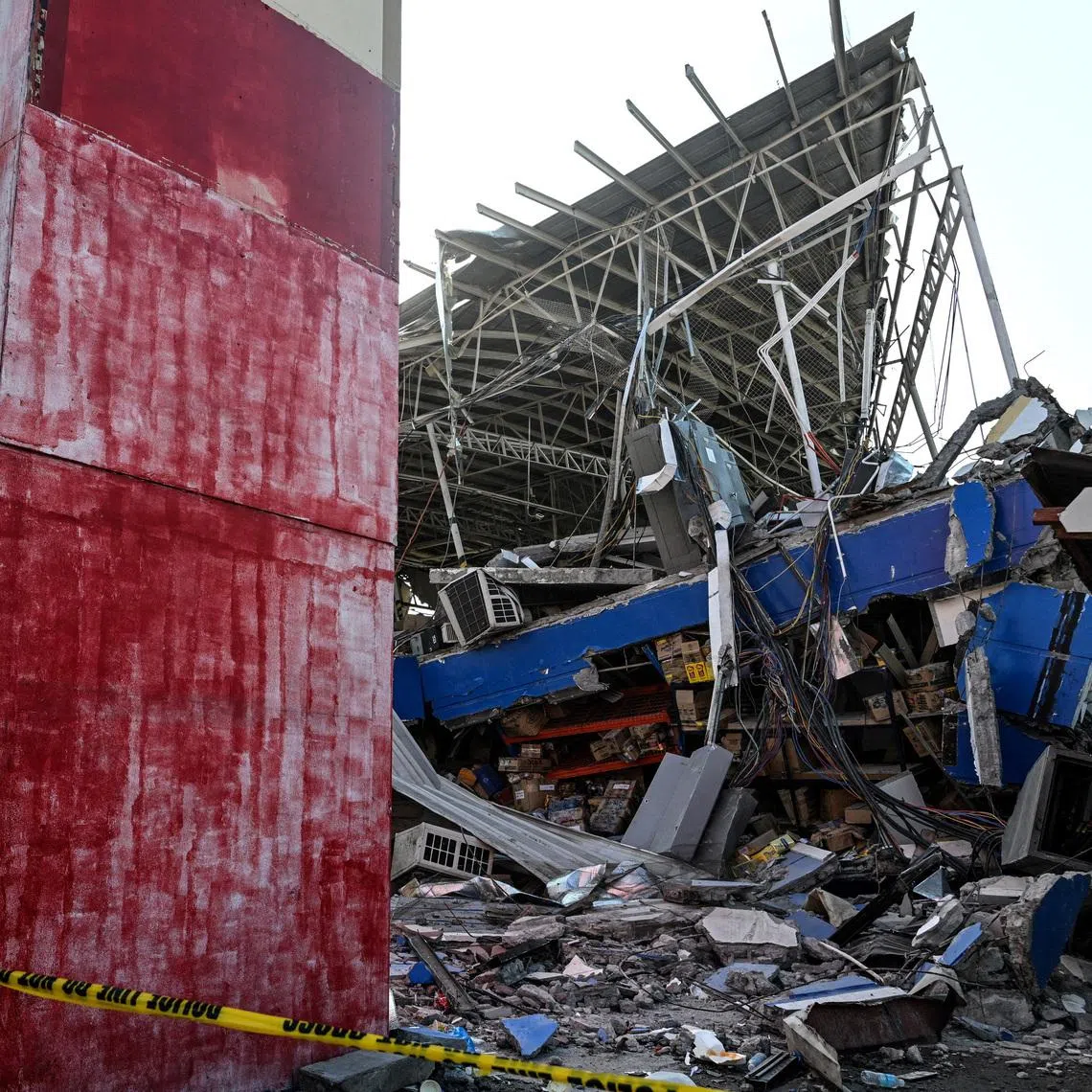 A collapsed grocery store in General Santos on June 9, a day after the southern Philippine city was struck by a 7.8-magnitude earthquake.