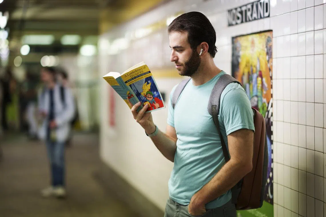Reading at a subway station in New York, Aug 15, 2024. 