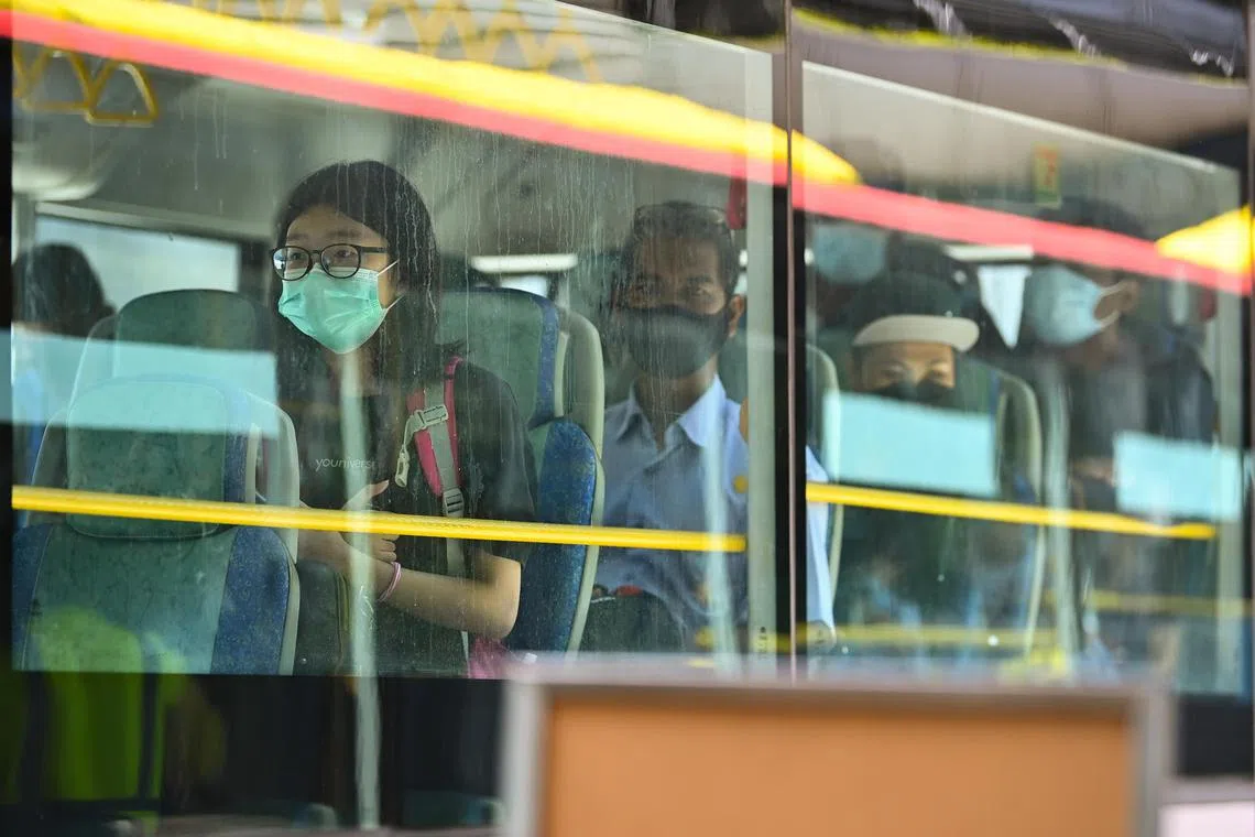ST20211129-202111872057-Lim Yaohui-aqvtl30/
Passengers from Malaysia inside their VTL bus to Singapore after going through immigration clearance during first day of operations of the VTL (Land) at Woodlands Checkpoint on Nov 29, 2021.
Singapore-Malaysia land VTL to open on Nov 29, up to 2,880 travellers each day.
Singapore bus company Transtar Travel will operate 16 daily trips from Larkin Sentral Bus Terminal in Johor Baru to Woodlands Temporary Bus Interchange from 9.30am to 7.30pm, and another 16 trips in the other direction from 8am to 6pm. The buses will run at intervals of 40 minutes.
Similarly, Malaysia bus company Handal Indah, also known as Causeway Link, will operate 32 daily VTL trips between Larkin Sentral and Queen Street Terminal here.
The first bus from Singapore to Malaysia will leave at 9am and the last bus will leave at 8.15pm. From Malaysia to Singapore, the first bus will be at 7.30am and the last bus will be at 6.45pm.
(ST PHOTO: LIM YAOHUI)