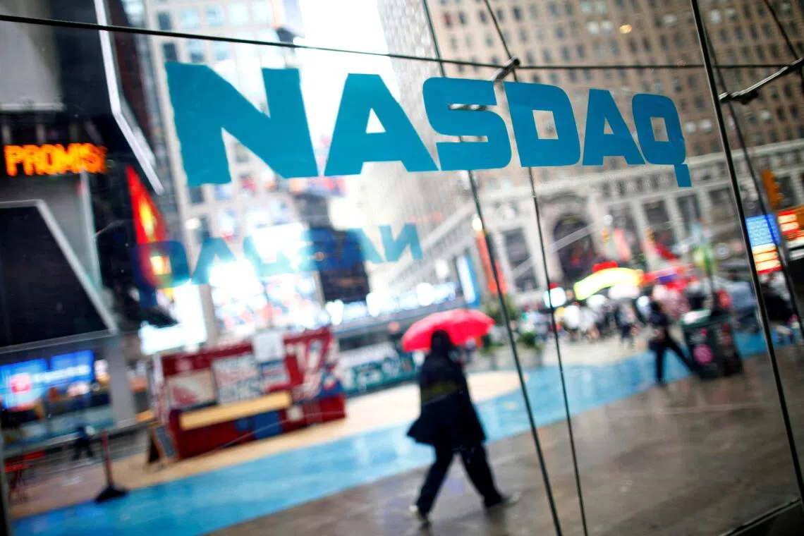 FILE PHOTO: Pedestrians walk past the NASDAQ MarketSite in New York's Times Square in this June 4, 2012 file photo. REUTERS/Eric Thayer/File Photo