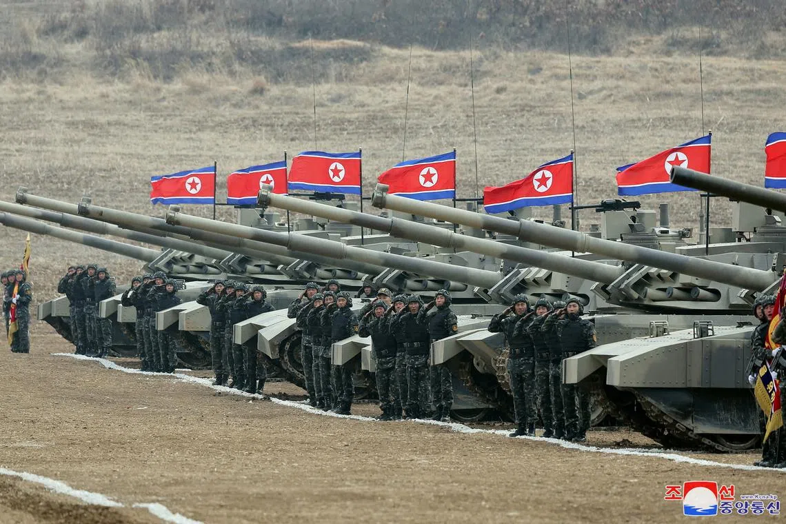 FILE PHOTO: Military members salute during a military demonstration involving tank units, guided by North Korean leader Kim Jong Un (not pictured), in North Korea, March 13, 2024 in this picture released on March 14, 2024, by the Korean Central News Agency.  KCNA via REUTERS/File Photo