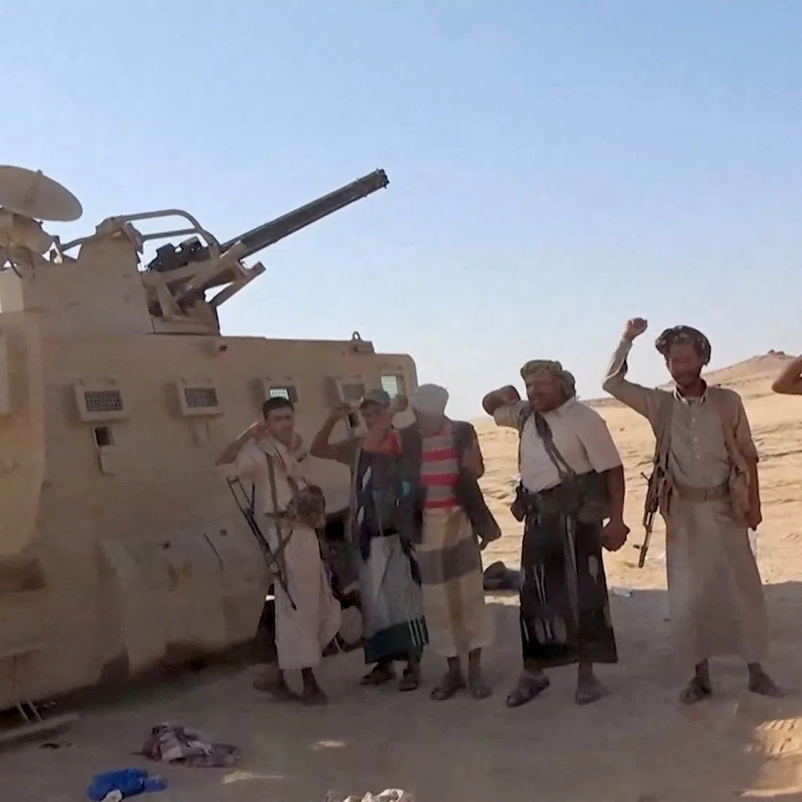 FILE PHOTO: Iran-aligned Houthi fighters pose next to a captured vehicle following what the source described as an attack on Saudi-backed forces in the location given by the source as al Jawf governorate, Yemen, in this screengrab taken from a video released by Houthi Military Media on September 15, 2026. HOUTHI MILITARY MEDIA/Handout via REUTERS