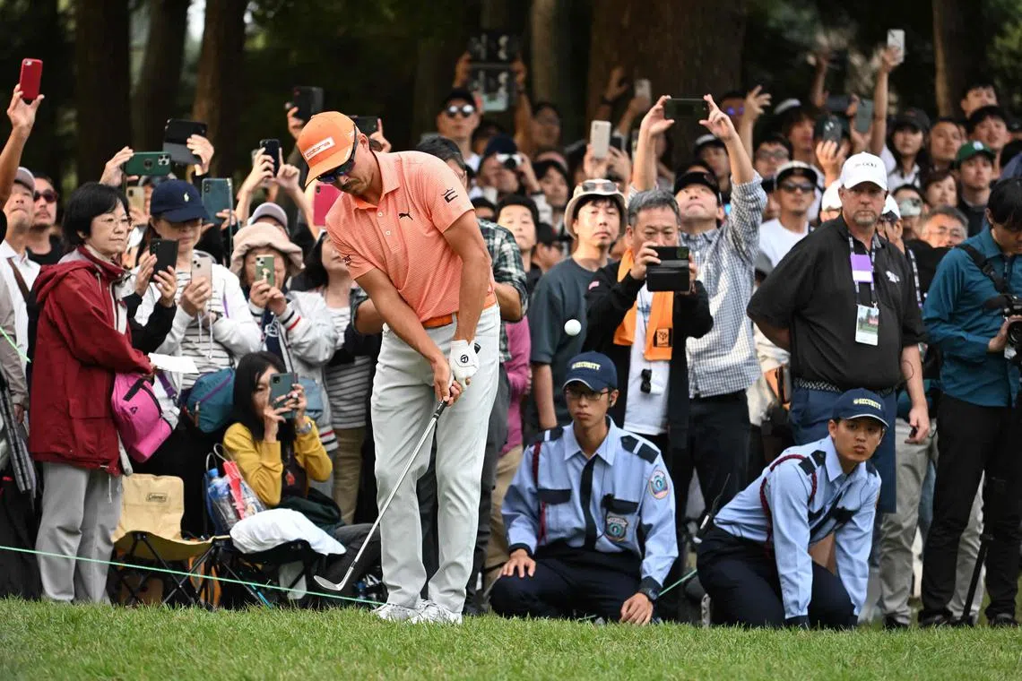 Rickie Fowler hits an approach shot beside the 18th green during the final round of the Zozo Championship.