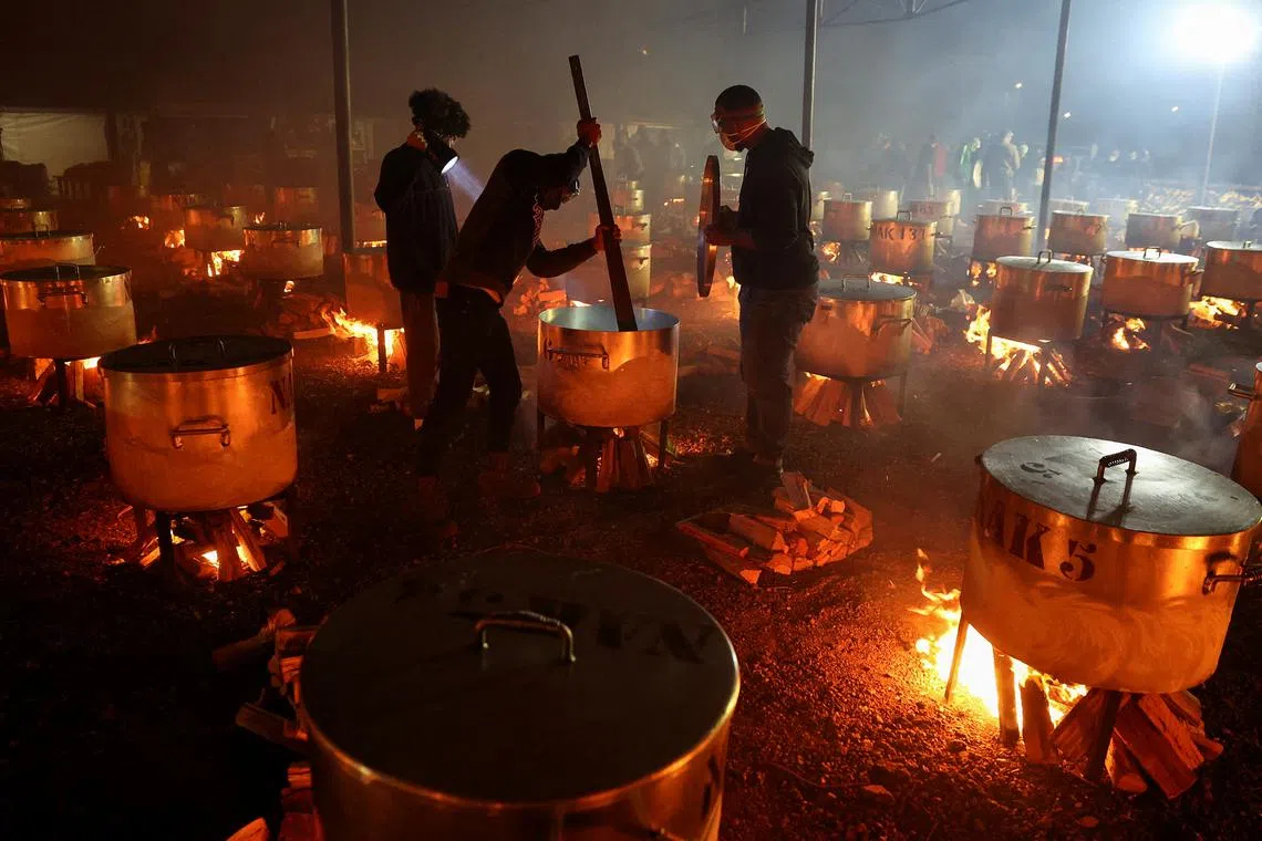 Volunteers helping to prepare more than 180 pots of food for less fortunate families to celebrate the end of the Muslim fasting month of Ramadan, in Cape Town, South Africa, on April 10, 2024. 