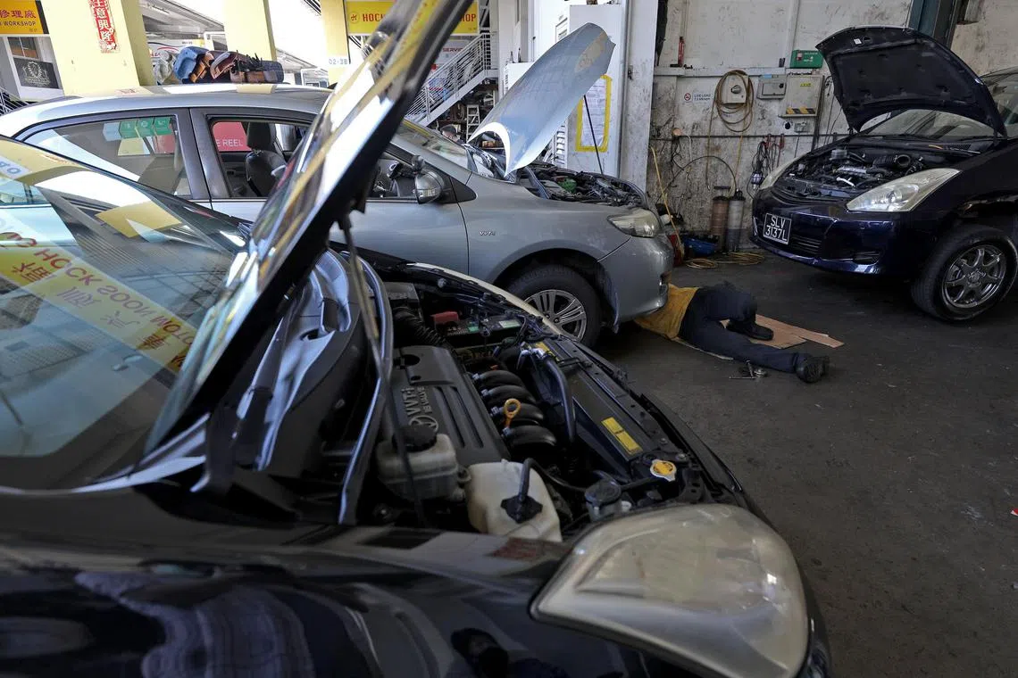 A mechanic servicing a car at Ong Hock Soon Motor Repair at Autobay@Kakit Bukit on June 2, 2020. Singapore has emerged from its circuit breaker period to resume some activities that had been shut down due to the Covid-19 outbreak.
