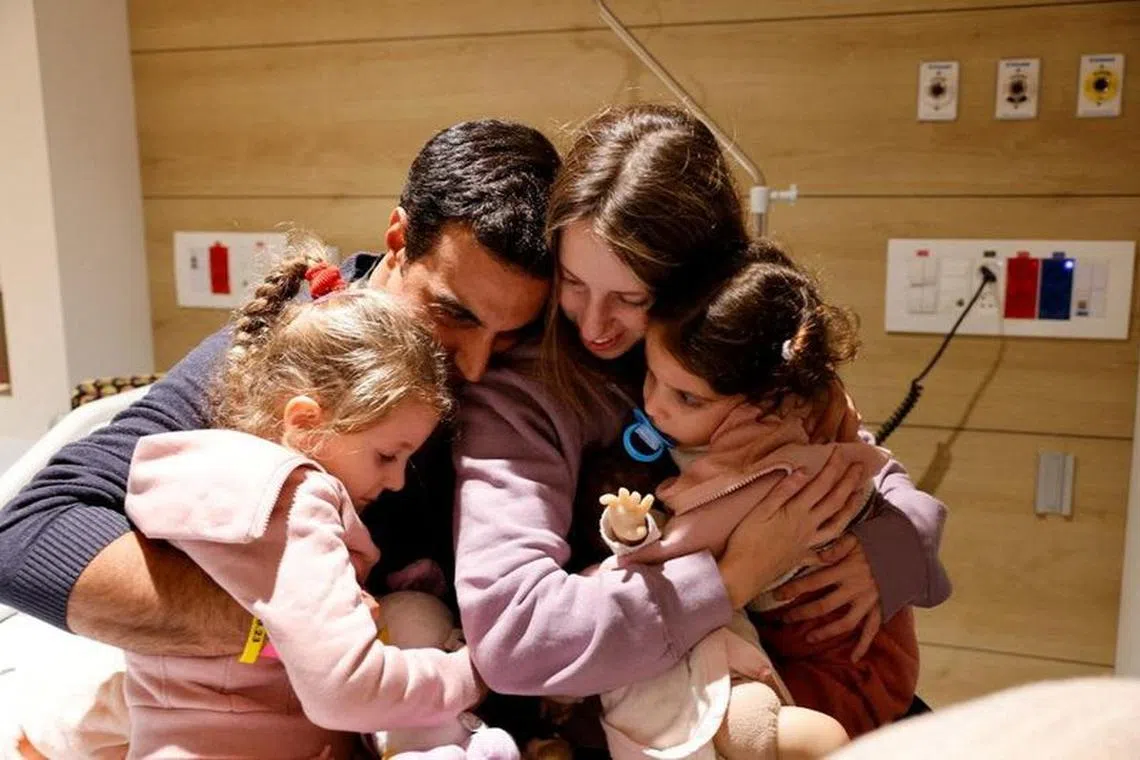 Aviv Asher, her sister Raz Asher and mother Doron react as they meet with Yoni, Raz and Aviv's father and Doron's husband, after they returned to Israel. Schneider Children's Medical Center Spokesperson/Handout via REUTERS. PHOTO COURTESY OF THE FAMILY