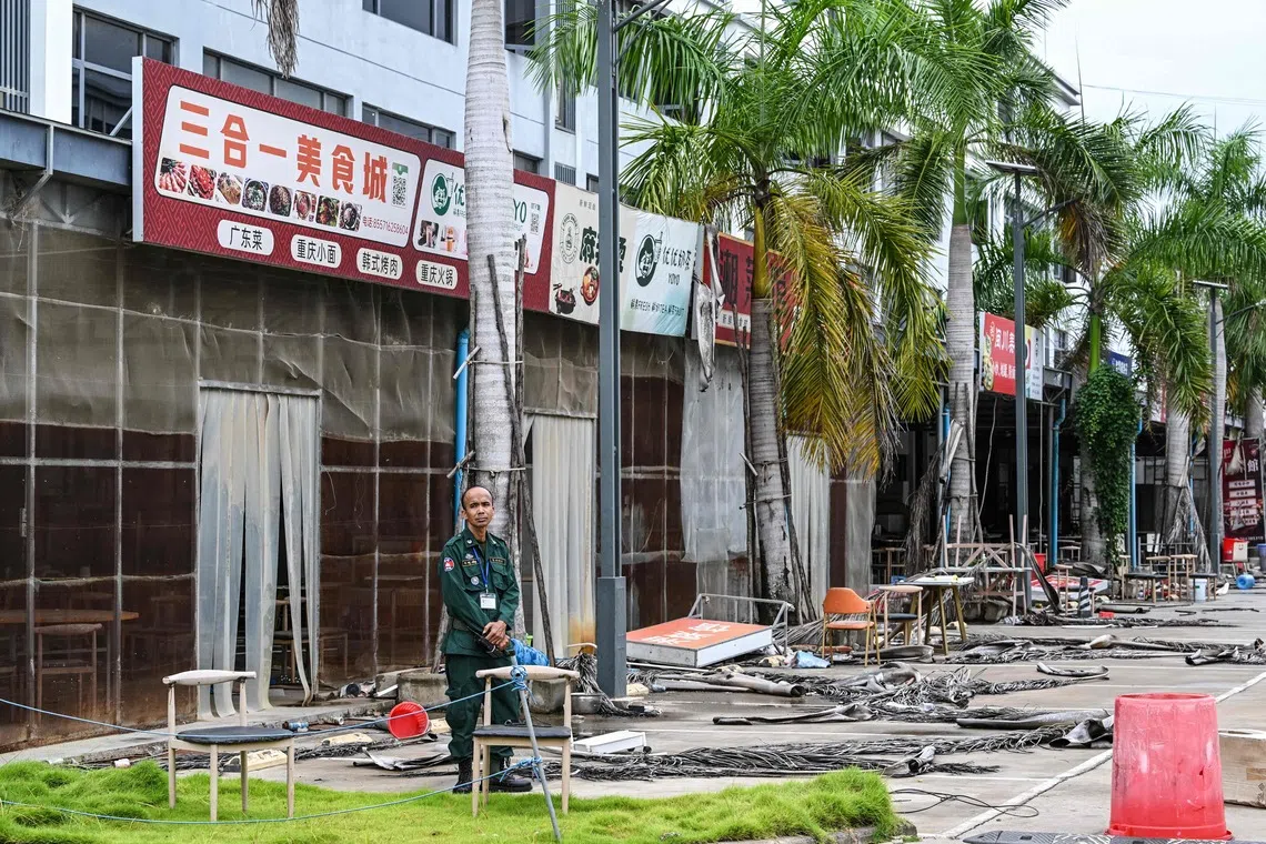A police official stands outside a building at a closed cyber scam centre compound in Kandal province on Sept 22.