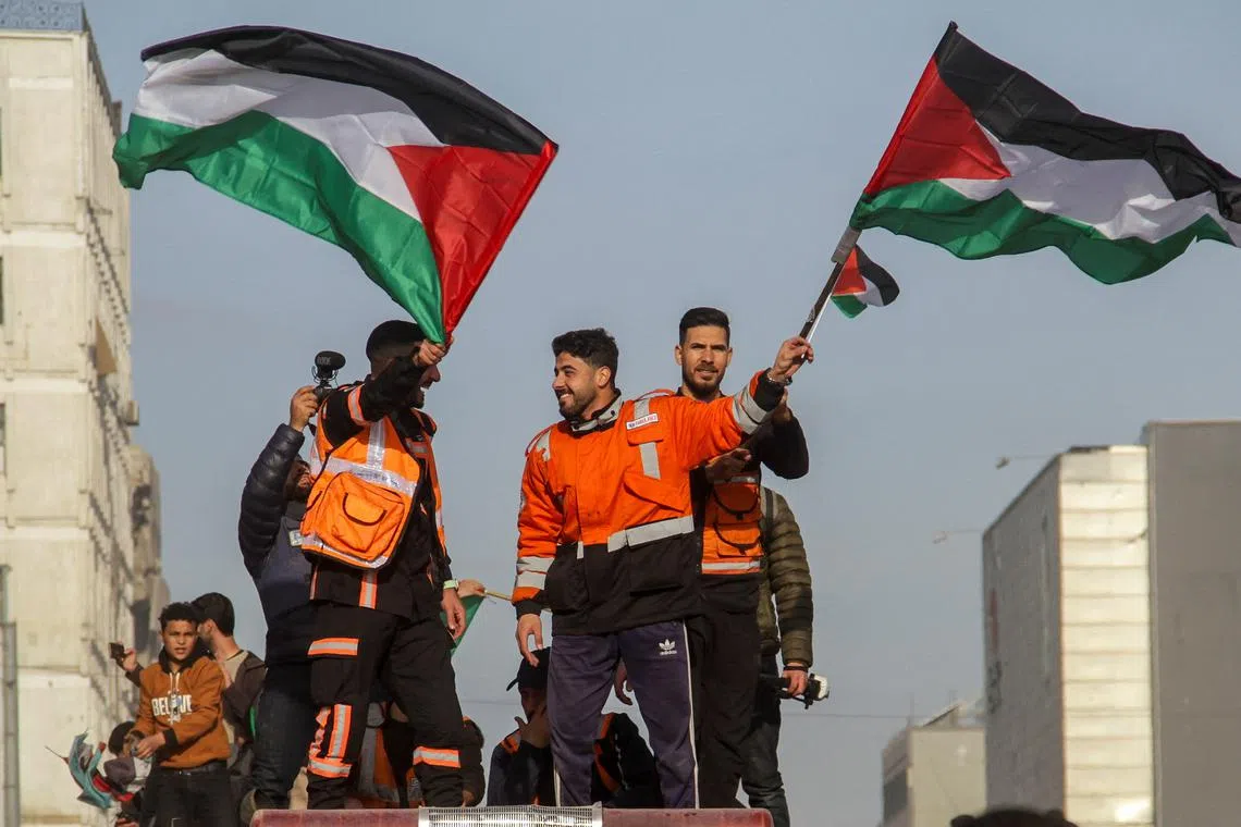 Members of the Palestinian civil emergency service celebrate in Gaza City, January 19, 2025. REUTERS/Mahmoud Issa
