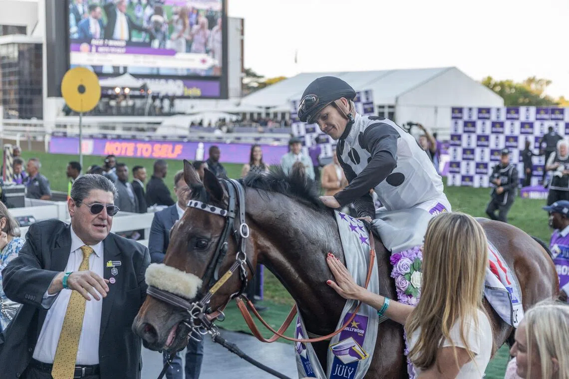 Jockey Richard Fourie rides "Note To Self" after winning the 2026 edition of the Durban July horse race in Durban on July 4, 2026. (Photo by RAJESH JANTILAL / AFP)