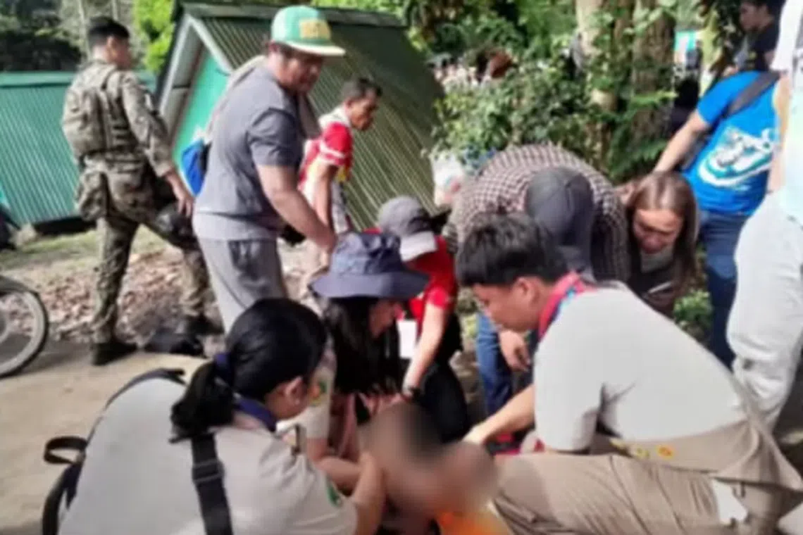 First responders try to revive one of the scouts who were electrocuted at a campsite in southern Philippines.