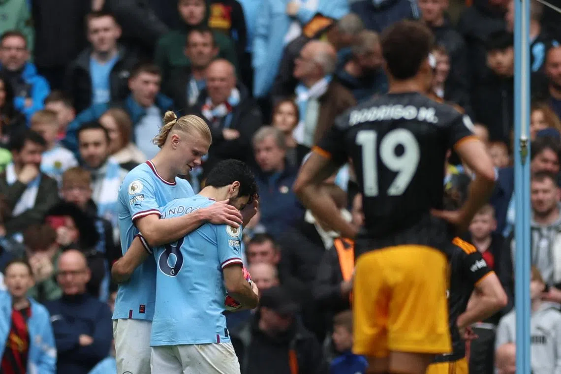 Manchester City's Erling Braut Haaland gives the ball to Ilkay Gundogan to take a penalty.