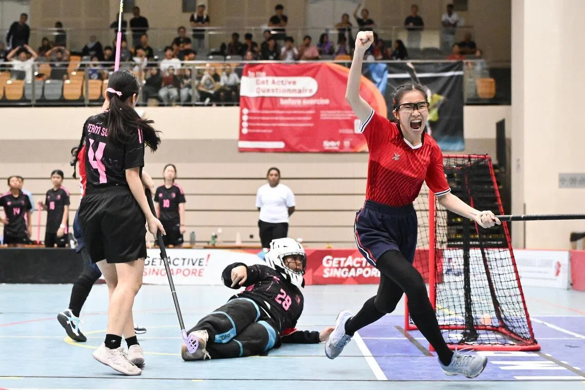 Dahya Nasrul Muhaimin (in red) celebrates after scoring one of her four goals in Marsiling Secondary School's 5-2 win over Swiss Cottage Secondary School in the National School Games floorball B Division girls' final.