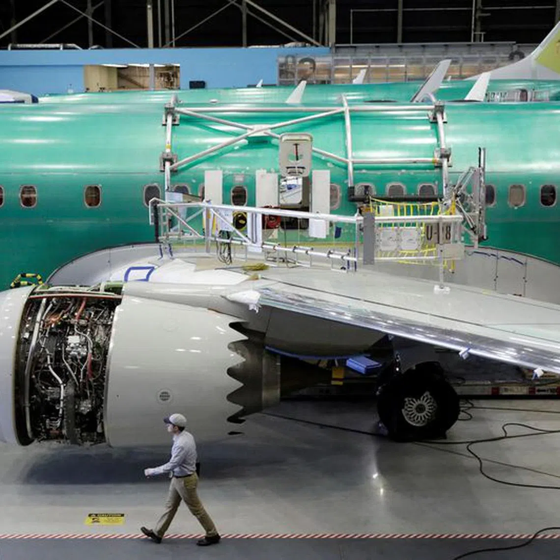 FILE PHOTO: A worker walks past Boeing's new 737 MAX-9 under construction at their production facility in Renton, Washington, U.S., February 13, 2017. Picture taken February 13, 2017. REUTERS/Jason Redmond/File Photo