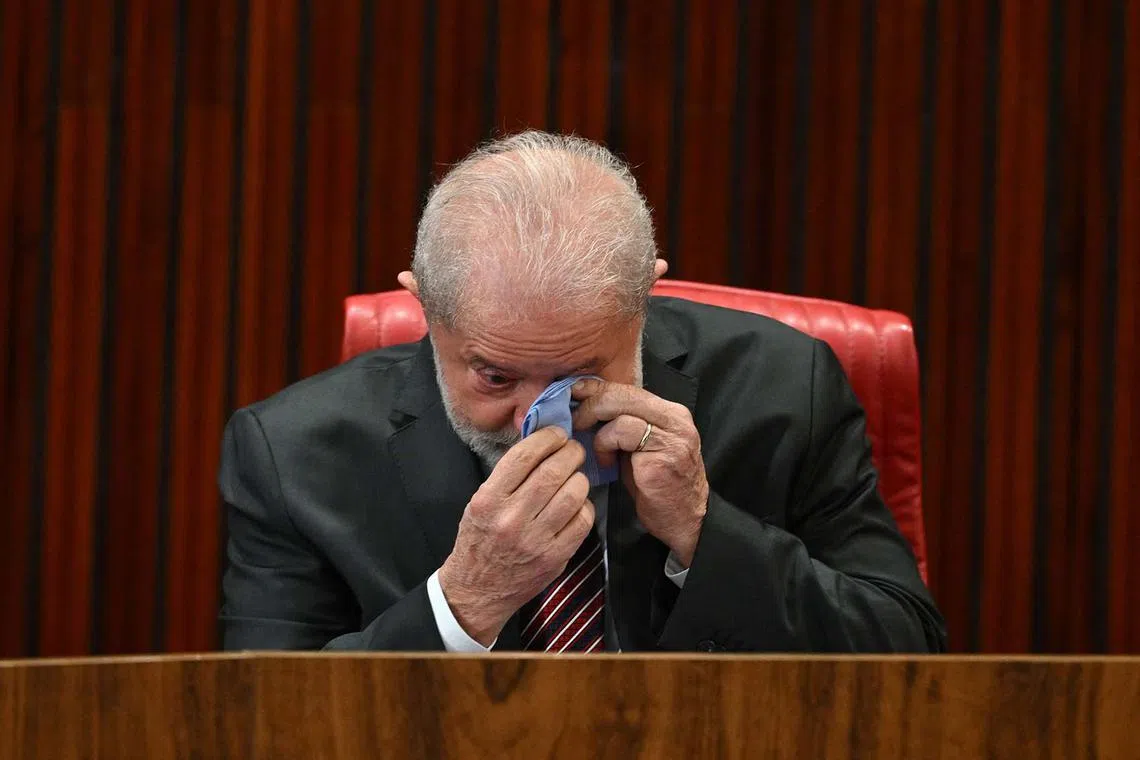 TOPSHOT - Brazil's President-elect Luiz Inacio da Silva cries during the certification ceremony at the Superior Electoral Court (TSE) headquarters in Brasilia, December 12, 2022. - Luiz Inacio Lula da Silva received this Monday the "diploma" of President-elect from the highest electoral authority in Brazil, which formalizes his path to take office on January 1, 2023. (Photo by EVARISTO SA / AFP)