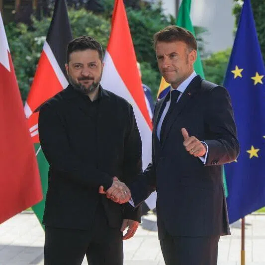France's President Emmanuel Macron greets Ukraine's President Volodymyr Zelensky on June 16 ahead of the working session with G-7 leaders and Ukraine during the summit in Evian, France.